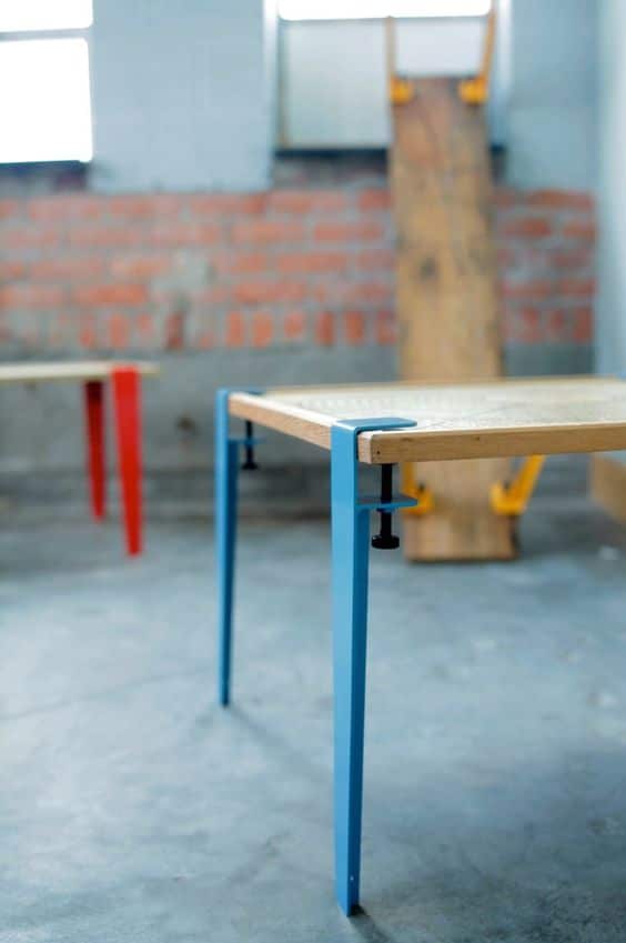 Table with blue top and two legs. Amp up the legs.