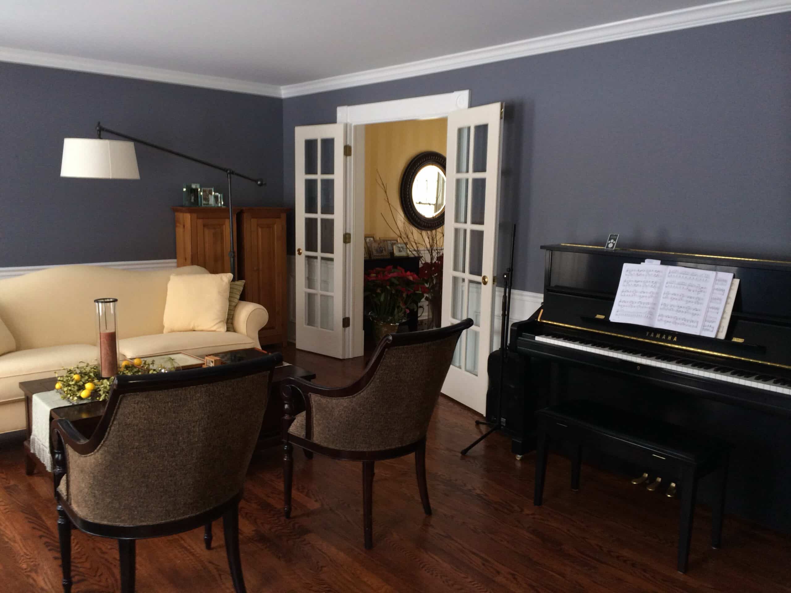 A Dior Gray piano elegantly placed in a living room, adding a touch of sophistication to the space