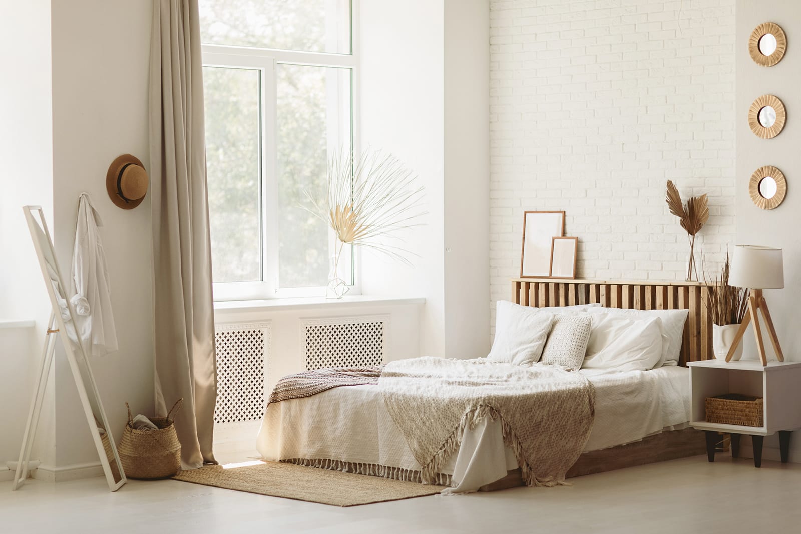 A pristine bedroom with white walls and a neatly made bed.