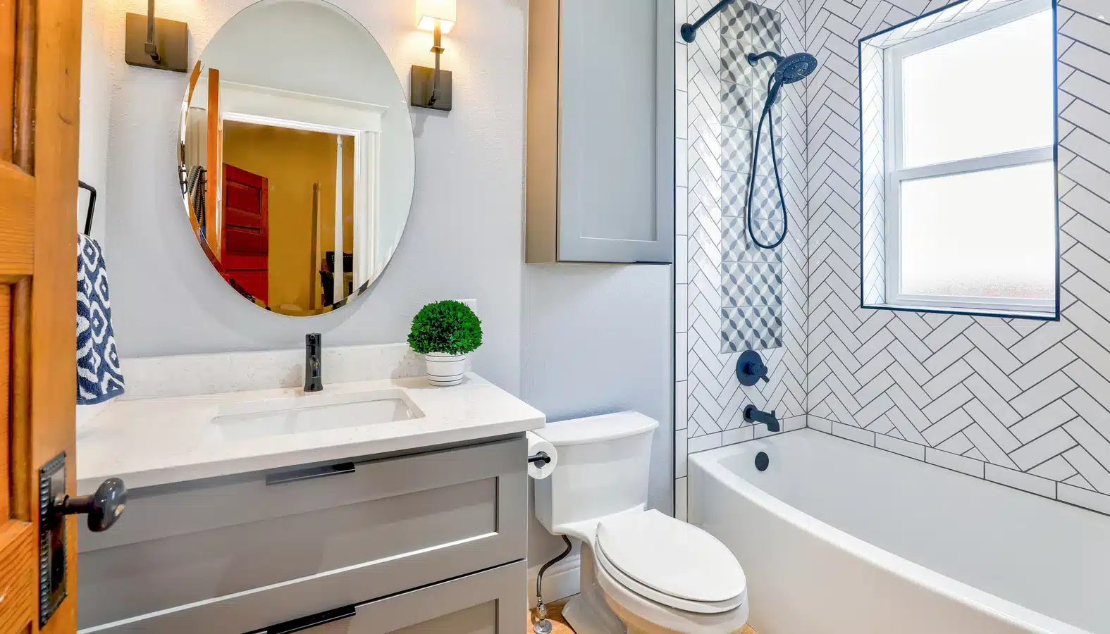 A bathroom with a white sink, toilet, and shower. Different sizes of bathrooms are available