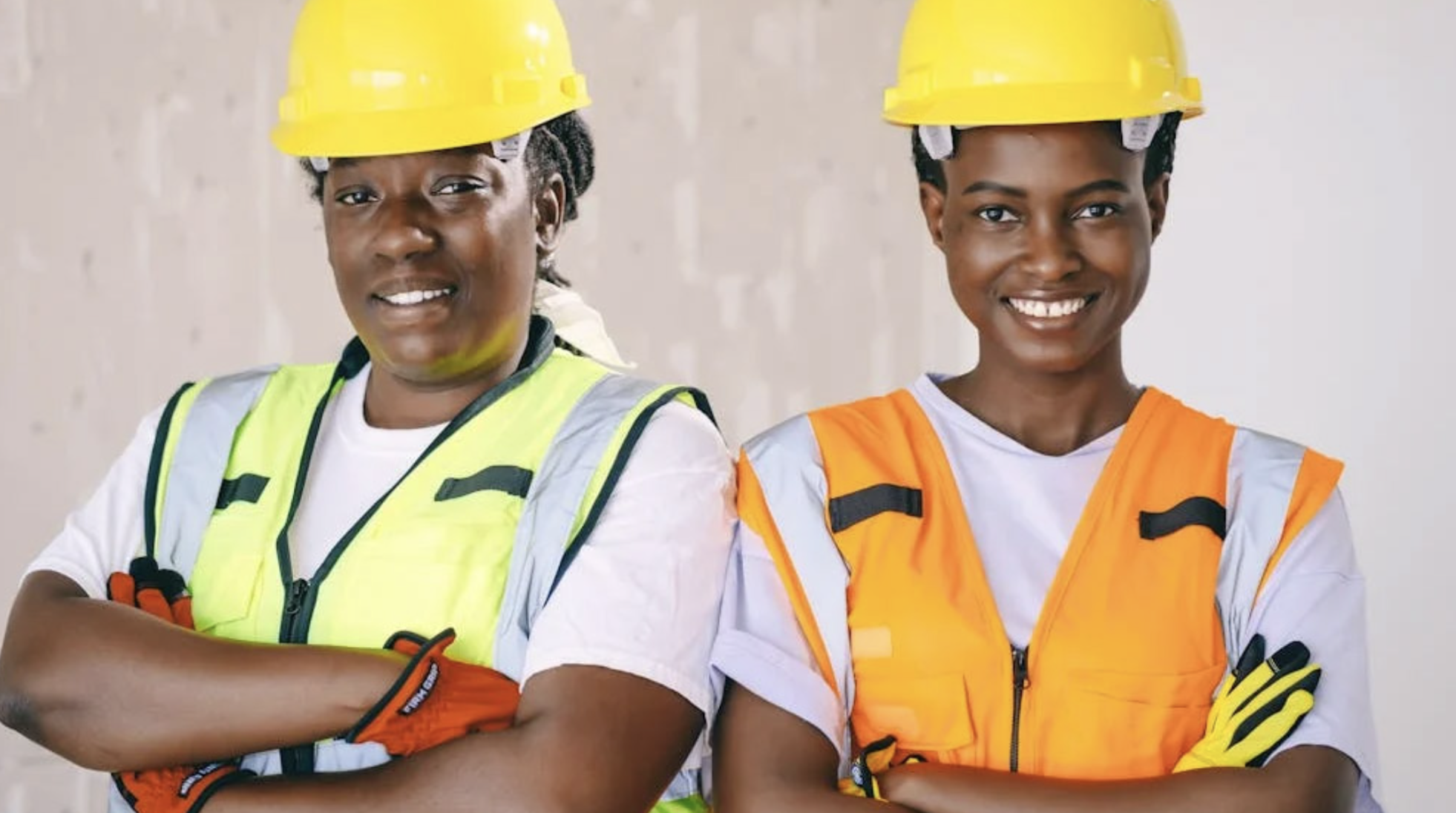 two female construction workers smiling confidently