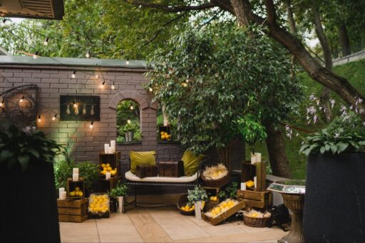 If you’re wondering how to decorate a garden without breaking the bank or losing your mind, you’re in the right place. A well-designed outdoor space can transform your entire home; giving you a place to relax, entertain, and enjoy the seasons. Whether you’ve got a sprawling lawn, a compact patio, or a narrow garden wall, the right garden decor can turn it into your ideal outdoor living room. The good news? You don’t need a landscape architect or a massive budget to make it work. From clever lighting and stylish garden furniture to playful touches like lawn games or a garden pizza oven, it’s all about making the most of your available space and adding personal flair. This guide walks you through the most practical and creative decor ideas, helping you plan, style, and decorate your garden so it’s both beautiful and useful. Ready to give your outdoor area a new lease on life? Let’s start with the most important step: planning it right. Start with a Plan Before buying a single watering can or stringing up fairy lights, take a moment to step back and really look at your space. A well-thought-out layout sets the tone for everything else and saves you time and money in the long run. Start by identifying what you want from your garden. Do you want an outdoor dining area for long summer evenings? A peaceful nook for reading? A play zone for the kids? Create zones that match your lifestyle — even in a small garden, this helps give each part of the outdoor space a clear purpose. Sketch a rough map of the garden. Mark out permanent features like trees, sheds, paths, and any existing garden fence or walls. Then, identify a focal point. This could be something bold like a garden pizza oven, a water feature, or a statement bench surrounded by potted plants. From there, layer in elements that draw attention to it; think climbing plants, raised beds, or a backdrop of evergreen foliage for all-season visual interest. Use natural materials like timber, stone, or gravel to connect the different areas and maintain a cohesive garden feel. And always think in varying heights: tall trees, medium-height planters, and low-growing flowers add depth and make the outdoor area feel more dynamic. Once your layout is clear, the fun part begins: turning those zones into something stylish and functional. Define an Outdoor Living Room Think of your garden as an extension of your home. Creating an outdoor living room makes it more inviting and functional, especially in the warmer months. It's where you can unwind, host friends, or even work with a coffee in hand and the surrounding greenery for company. Start with seating. Choose garden furniture that suits your space: a corner sofa, a couple of weatherproof chairs, or even a hammock can work. Stick to materials made for outdoor use, like rattan, teak, or powder-coated metal. To soften the look, layer on cushions, throws, and an outdoor rug to define the outdoor seating area and make it feel like a proper room. Add a coffee table or side tables for drinks, books, or even potted succulents. Surround the area with potted plants, low planters, or a trellis of climbing plants for a cosy, enclosed feel. Use a garden wall or garden fence as a backdrop and give it a fresh coat of paint. A neutral tone works well, but don’t shy away from bold colour if you want to make a statement. Lighting is key here. String fairy lights overhead, place lanterns at different heights, or add solar-powered stake lights around the perimeter. If you're working with a small garden, mirrors, and wall art can help bounce light and create the illusion of more space. This zone should feel effortless — think laid-back comfort with a bit of personality. A few well-placed garden ornaments, a woven basket for throws, and a set of watering cans styled like decor can really tie it all together. alt=”traditional outdoor wood-fired pizza oven” Create a Garden Dining Area Nothing says summer like outdoor dining. Whether you're hosting weekend brunches or casual pizzas under the stars, a dedicated dining area in your garden is a smart, stylish addition. Start with the essentials: a good outdoor table and sturdy chairs. Choose a set that matches your lifestyle: something compact for a small garden, or a long rustic table if you’ve got the space. Materials matter here too: stone, metal, or hardwoods like teak can handle weather and wear while offering a clean, timeless look. To define the zone, place your dining set on a paved patio, gravel base, or even a rug made for outdoor use. Consider adding a pergola, sail shade, or even repurposed tree branches overhead for a mix of form and function. This also gives you a spot to hang fairy lights, paper lanterns, or vintage bulbs for that perfect evening glow. Surround the space with planters, potted plants, or low raised beds filled with herbs and flowers. Incorporate climbing plants to add height and frame the scene. One great idea: place your garden pizza oven nearby, so food can move seamlessly from oven to table. It makes for an unforgettable experience and serves as a natural focal point. You'll find everything you need for setting up an outdoor pizza oven (even a DIY one) at Vitcas Shop. Want to elevate the decor? Add a table runner, outdoor-safe crockery, and a few seasonal centrepieces: think vases of fresh flowers, bowls of citrus, or lanterns for evening meals. Little touches go a long way in making the dining area feel welcoming, stylish, and part of your overall garden decor. Add Personality with Garden Ornaments and Decor Once the main zones are in place, it’s time to inject personality. The right garden ornaments and accessories can transform your outdoor space from plain to full of character, and it doesn’t have to be expensive. Start with objects that make you smile: vintage signs, sculptures, old lanterns, or even a row of painted watering cans. These kinds of pieces give your garden its own story. Use wall art on your garden wall or fence to break up empty vertical space: metal cut-outs, ceramic plaques, or even framed prints designed for outdoor use all work brilliantly. Mirrors can help bounce light and visually expand a small garden. Think about repurposing everyday items. An old stepladder becomes a tiered plant stand, while crates or palettes can be stacked for quirky shelving. Try hanging picture frames around trailing plants for a playful gallery-style look. Keep it cohesive. Choose a colour scheme or material (like terracotta, zinc, or reclaimed wood) and repeat it throughout your garden decor for a pulled-together, intentional look. A few standout items placed with purpose create more impact than cluttering the space. Add texture by mixing materials, like metal, glass, wood, ceramic. This brings in visual interest and complements your plants. And don’t forget sound: a wind chime or small bubbling water feature adds an extra layer to your garden feel that’s subtle but effective. alt=”small garden decorations in a flowerbed” Add Potted Plants and Raised Beds If there’s one thing that instantly lifts a garden, it’s potted plants. Whether you’ve got a compact patio or a generous lawn, adding greenery in pots and planters is one of the easiest and most versatile decor ideas. Use a mix of varying heights and pot sizes to avoid a flat look. Combine floor-standing planters with raised shelves, hanging pots, and steps to create a layered effect. Group pots in odd numbers for a more natural layout, and choose materials that suit your style: terracotta for rustic charm, concrete for clean minimalism, or bright glazed pots for a cheerful burst of colour. Include a mix of evergreen foliage, flowering plants, and herbs. This ensures year-round appeal and brings scent, texture, and colour to your outdoor area. Climbing plants like jasmine or clematis can be trained up trellises or garden walls, adding vertical interest and softening hard lines. If you’ve got room, build or buy raised beds. These are ideal for creating structure and defining walkways or zones. Fill them with seasonal flowers, vegetables, or pollinator-friendly plants to support wildlife. Use containers to frame key areas like your outdoor seating area or dining area, creating boundaries without walls. And for those with a small garden, hanging planters and wall-mounted pots are a great idea to keep things off the ground but still lush. These flexible, budget-friendly solutions make it easy to swap things out with the seasons, giving your garden a new lease on life throughout the year. Lighting for Ambience and Function Lighting can completely transform your garden, taking it from a plain outdoor area to a warm, inviting haven once the sun goes down. It also makes your garden safer and more usable at night, whether you’re hosting guests or just enjoying a quiet cup of tea. Start with the basics: illuminate paths and steps using stake lights or low-level LED strips. This helps with safety and highlights the flow of your space. Then, layer in ambient lighting. Fairy lights are a go-to choice — drape them across fences, string them through tree branches, or hang them above your dining area or outdoor seating area for an instant mood boost. Lanterns (solar or battery-powered) add a soft, flickering glow and can be moved around easily. Wall-mounted lights or sconces along your garden wall help define vertical space and can double as wall art if chosen well. If you want a bit more drama, use spotlights to highlight a focal point: maybe a sculptural tree, a water feature, or an eye-catching piece of garden decor. Keep the colour temperature warm for a cosy, relaxing atmosphere. Lighting is about more than just visibility; it adds emotion, depth, and function to your garden feel. Paint and Refresh Existing Features Not everything has to be built from scratch, sometimes the best decor ideas involve simply refreshing what you’ve already got. A fresh coat of paint on a tired garden fence, shed, or bench can make a world of difference and give the space a more polished, cohesive look. Start with the walls and boundaries. Painting your garden wall or fence in a dark shade (like charcoal or forest green) makes the greenery pop and gives your garden a modern edge. Lighter tones, like soft sage or warm neutrals, can make a small garden feel bigger and brighter. Don’t forget furniture and fixtures: metal chairs, watering cans, or planters can be revived with outdoor spray paint. Wooden garden furniture can be sanded and oiled or painted in cheerful colours to add personality. Consider patterns too. Paint stripes or a geometric design on a patio floor, or stencil motifs onto plant boxes or raised beds. It’s a budget-friendly way to bring in some style and creativity without investing in new pieces. Reviving existing elements helps your garden feel cared for and updated, breathing new life into your outdoor space with minimal effort. alt=”ambient garden lighting” Use Vertical Space for Visual Interest When floor space is limited, or even when it’s not, going vertical is a great idea. It draws the eye upward, adds layers of texture, and maximises every bit of your available space. It’s especially useful in a small garden or balcony-style setup. Start by looking at your walls, fences, and even the sides of sheds. Install brackets or shelves to hold potted plants, small sculptures, or lanterns. Mount hanging planters or use vertical pocket planters for herbs, trailing vines, or flowers. This kind of setup doubles as a living wall, which not only looks striking but also improves air quality and supports biodiversity. Climbing plants like honeysuckle, ivy, or clematis can be trained over trellises or arches. You can even frame a seating or dining area with vertical greenery to give it that lush, enclosed feel. Use multi-level plant stands or tall planters to stagger heights and break up flat areas. Hanging baskets filled with cascading blooms are another simple way to add movement and charm. By using vertical space thoughtfully, you bring in visual interest, increase your planting area, and give your garden a layered, professional finish; no matter how much ground you’re working with. Incorporate Lawn Games and Family Fun Decorating your garden isn’t just about looks, it’s about lifestyle. If you have kids, pets, or just love entertaining, building in elements of fun is a great idea. A well-placed area for lawn games can add both function and personality to your outdoor space. Keep part of the lawn clear and level for games like boules, croquet, or giant Jenga. If your space is tight, consider foldaway or multi-use options that can be stored when not in use. Use raised beds or planters to frame the play area, making it feel intentional rather than just leftover turf. Hang a swing from sturdy tree branches, install a hammock between posts, or add a chalkboard to a garden wall for kids’ drawing space. These touches invite interaction and make your garden a true extension of your home. To keep things tidy, go for dual-purpose storage. Benches with built-in compartments or waterproof boxes can house outdoor toys, cushions, or even picnic gear, keeping your garden decor looking clean and organised. Style It Like the Pros (Inspiration + Finishing Touches) Now comes the fun part: bringing it all together with layers of style, comfort, and detail. Pros like Sara Ligorria Tramp and Amy Bartlam nail that effortless, lived-in vibe by combining utility with charm. Here’s how to do the same. Blend your indoor and outdoor worlds. Choose textiles, colours, and decor that echo your interior palette: it creates a fluid transition and makes your garden feel like a real room, not an afterthought. For example, use throws, scatter cushions, and outdoor rugs that match your indoor tones. Add finishing touches: ceramic pots filled with herbs, glass jars turned lanterns, or a small tray of drinks on the outdoor table. Group potted plants near seating, dot garden ornaments along borders, and place picture frames or decorative wall art on fences for added charm. Don’t be afraid to experiment. Try a bold feature wall behind your outdoor seating area, or use mixed materials, woven rattan, painted metal, reclaimed wood, for texture. Little DIY upgrades go a long way and make your garden feel uniquely yours. In the end, it's not about perfection; it’s about creating a space that works for your life and reflects your personality. The right combination of practical design and creative flair can turn even the simplest garden into your favourite outdoor area. Summary Learning how to decorate garden spaces doesn’t require a design degree — just a bit of planning, creativity, and inspiration. From setting up a cosy outdoor living room, to defining a stylish dining area, adding potted plants, or even building your own garden pizza oven, the possibilities are endless. Every element, whether it’s garden furniture, lighting, climbing plants, or clever wall art, adds another layer to your garden’s story. Use what you have, refresh what you can, and don’t shy away from personal touches or DIY details. Even the smallest upgrades can give your garden a new lease on life. So grab your watering cans, pick a spot, and start bringing your vision to life. With the right decor ideas, your outdoor space will be more than just a garden. It’ll be your favourite place to be.