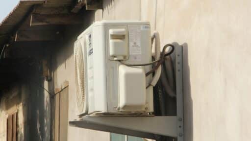 a white phone mounted to the side of a building