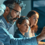 team of people focused on a computer screen that shows a knowledge management software guide