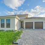 Modern house with a paved driveway and garage.