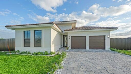 Modern house with a paved driveway and garage.