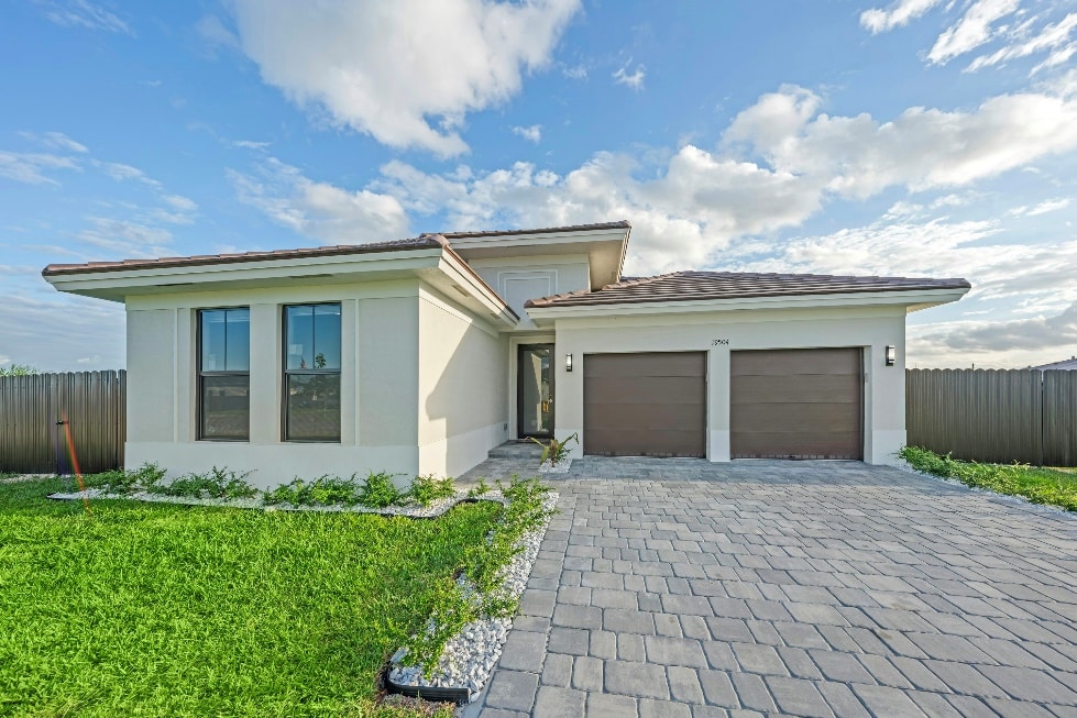 Modern house with a paved driveway and garage.