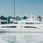 a large white boat in the water near a building