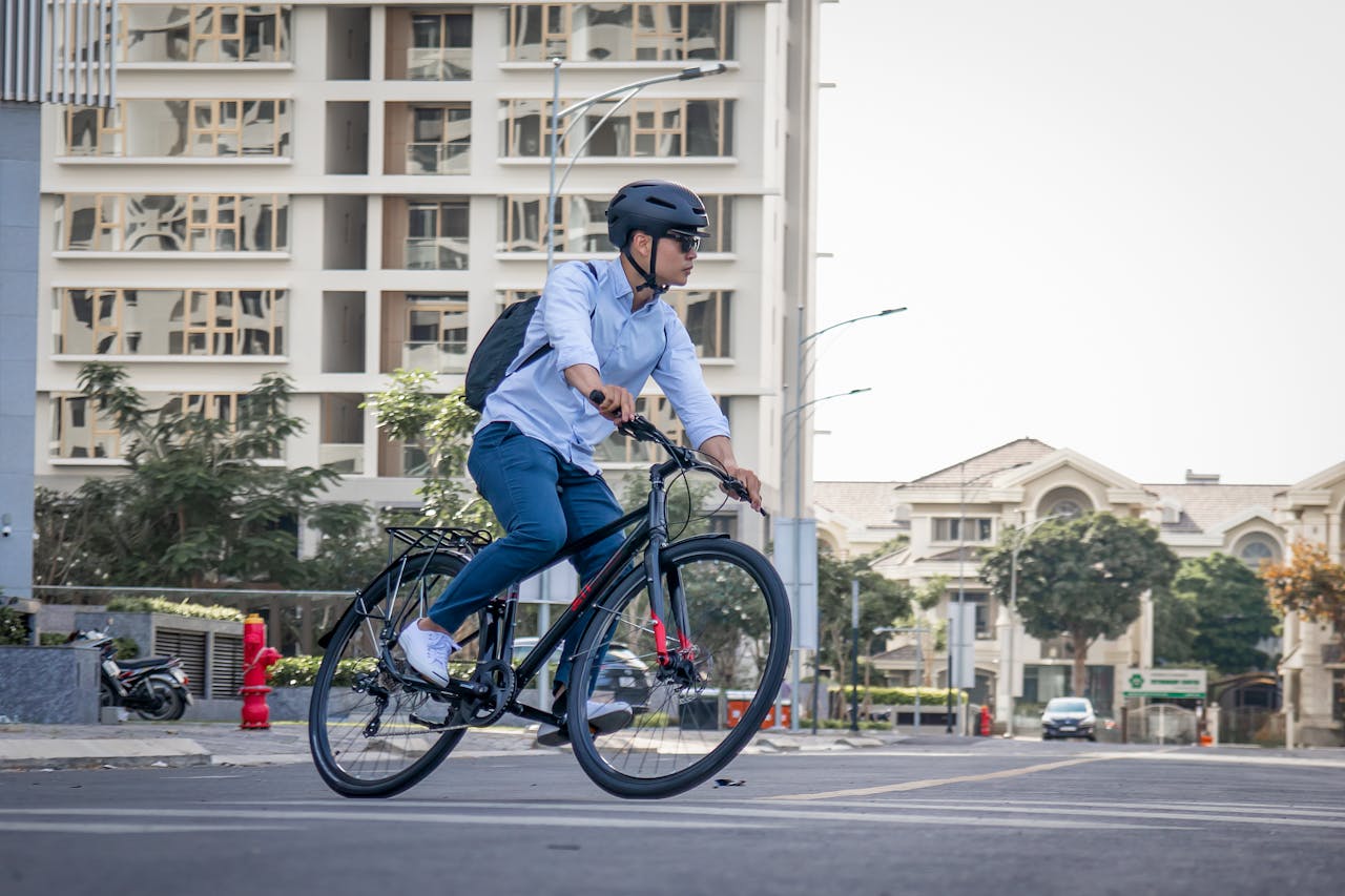 a young man riding his bike in a city