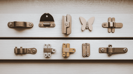 a flat lay of multiple hinge types including concealed butt butterfly strap and soft-close hinges arranged on a light grey surface