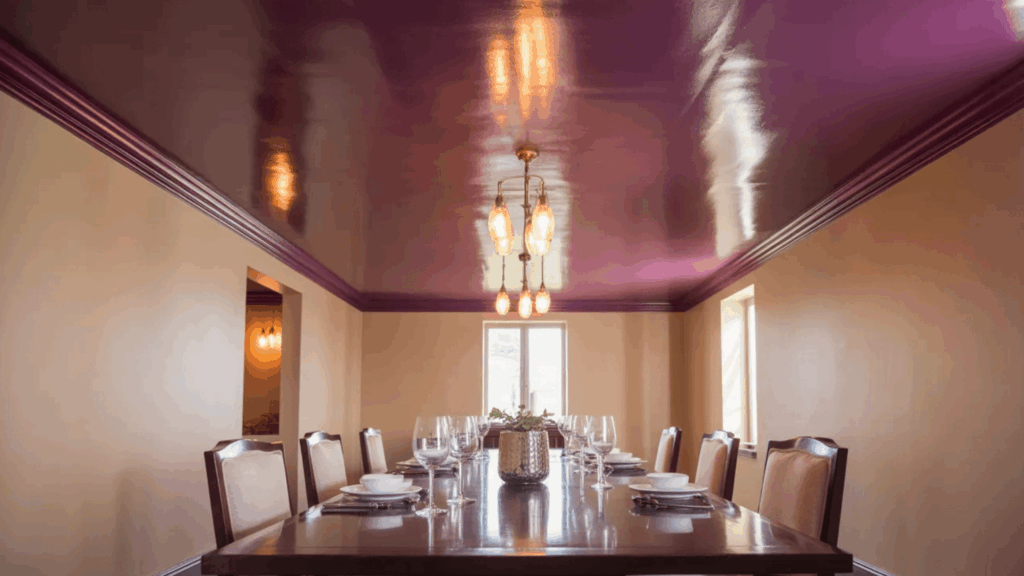 dining room with a plum ceiling, modern chandelier, and a large wooden table set for dinner
