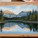landscape painting using acrylic paint on wood, showcasing mountains, trees, and a reflection in a serene lake with a paintbrush on the side