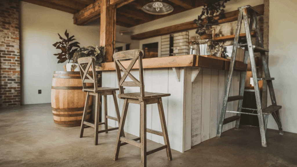 rustic kitchen with wooden bar stools, a barrel, and a step ladder beside the bar counter