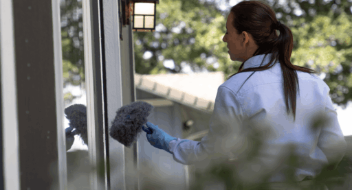 Woman checking the window sill.