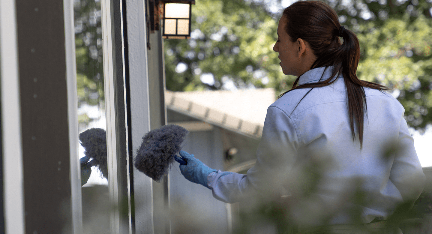 Woman checking the window sill.